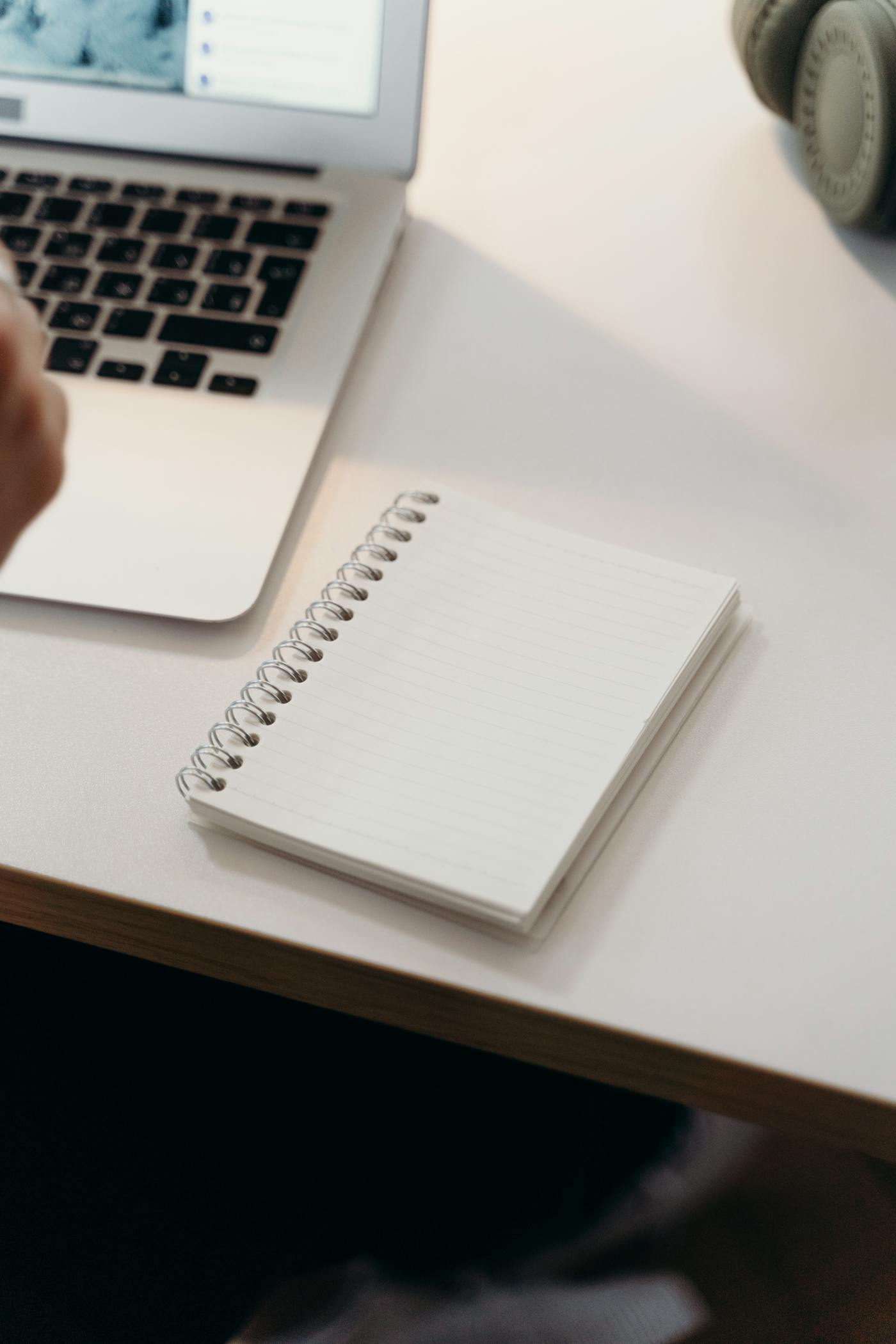 An open notebook on a clean white desk